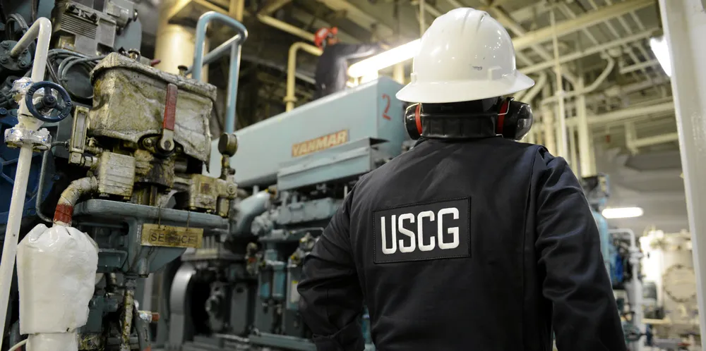 A marine inspector with Coast Guard Sector Miami inspects the engine room of a container ship.