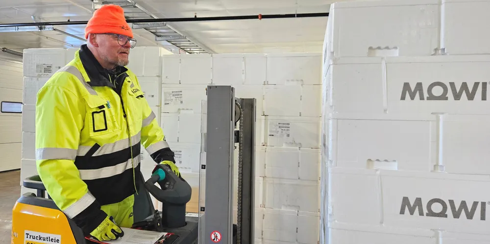Mowi logisitics operator Rolf Christensen drives an electric forklift loaded with pallets of salmon at the new site.