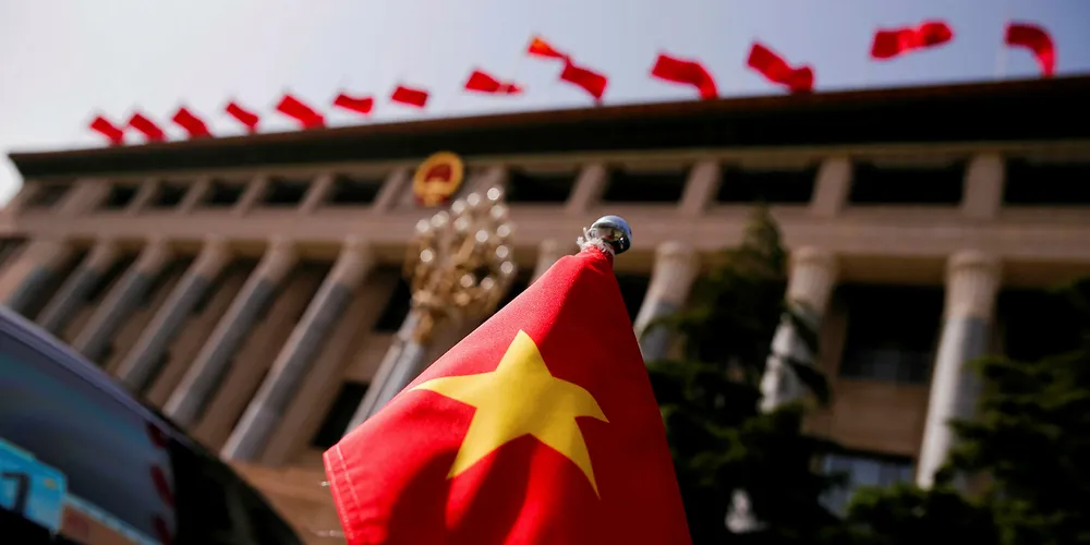 The Vietnamese national flag flies on a diplomatic car.