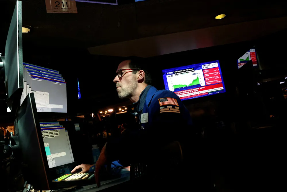 A specialist trader works inside a booth on the floor at the New York Stock Exchange (NYSE) in New York City, U.S., April 8, 2025.
