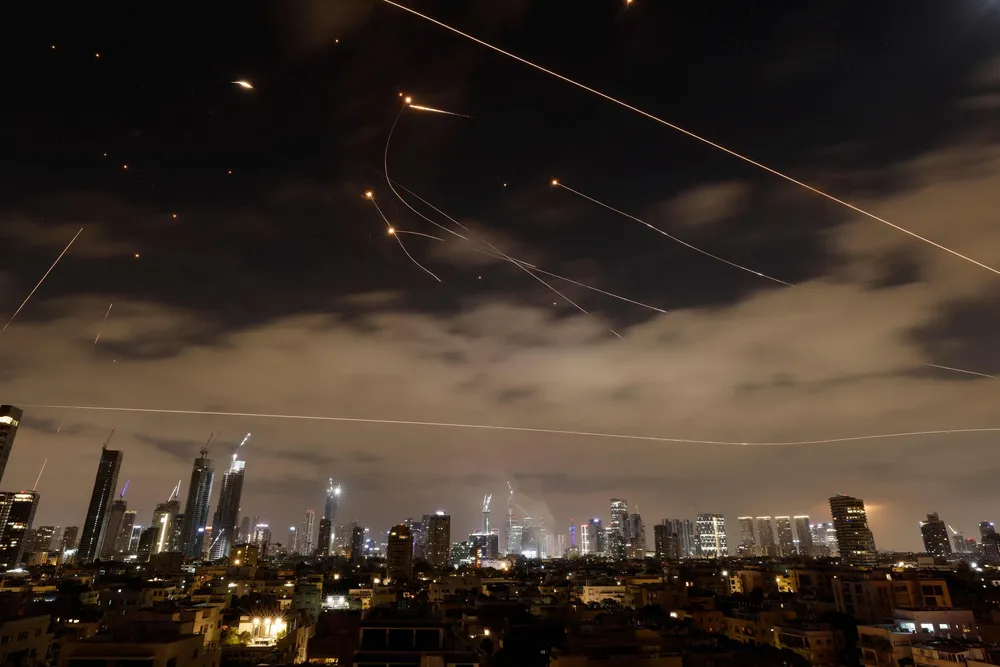 Israeli air defence systems are activated to intercept Iranian missiles over the Israeli city of Tel Aviv amid a fresh barrage of Iranian rockets on 16 June.