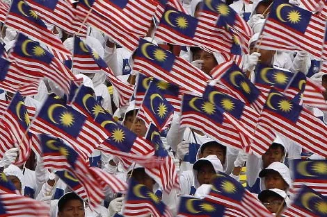 In unison: Malaysian students wave national flags during the 56th National Day celebrations in Kuala Lumpur on 31 August