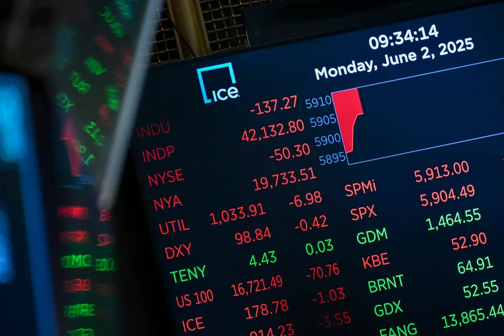 Market statistics are displayed on a screen as traders work on the floor of the New York Stock Exchange at the opening bell earlier this month.