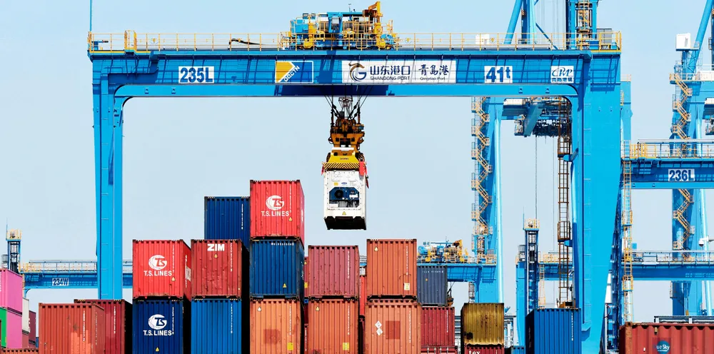 A gantry crane moves containers at a port in Qingdao, in eastern China's Shandong province, in June. The autonomous Zhi Fei will run on a feeder service to from Qingdao to the port of Dongjiakou.
