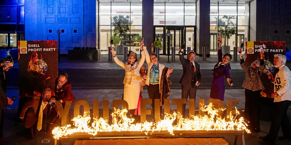 Greenpeace protestors stage a mock boardroom party outside Shell headquarters.