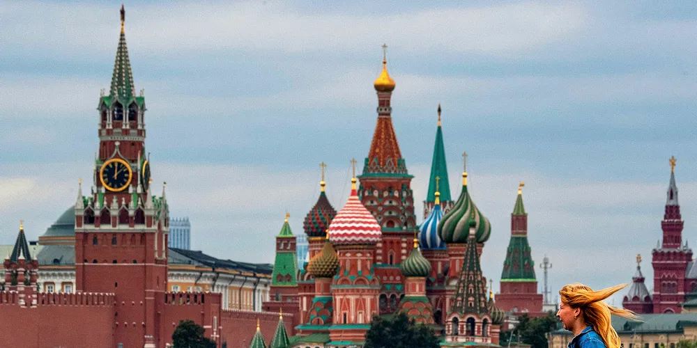 A woman walks near the Kremlin in central Moscow