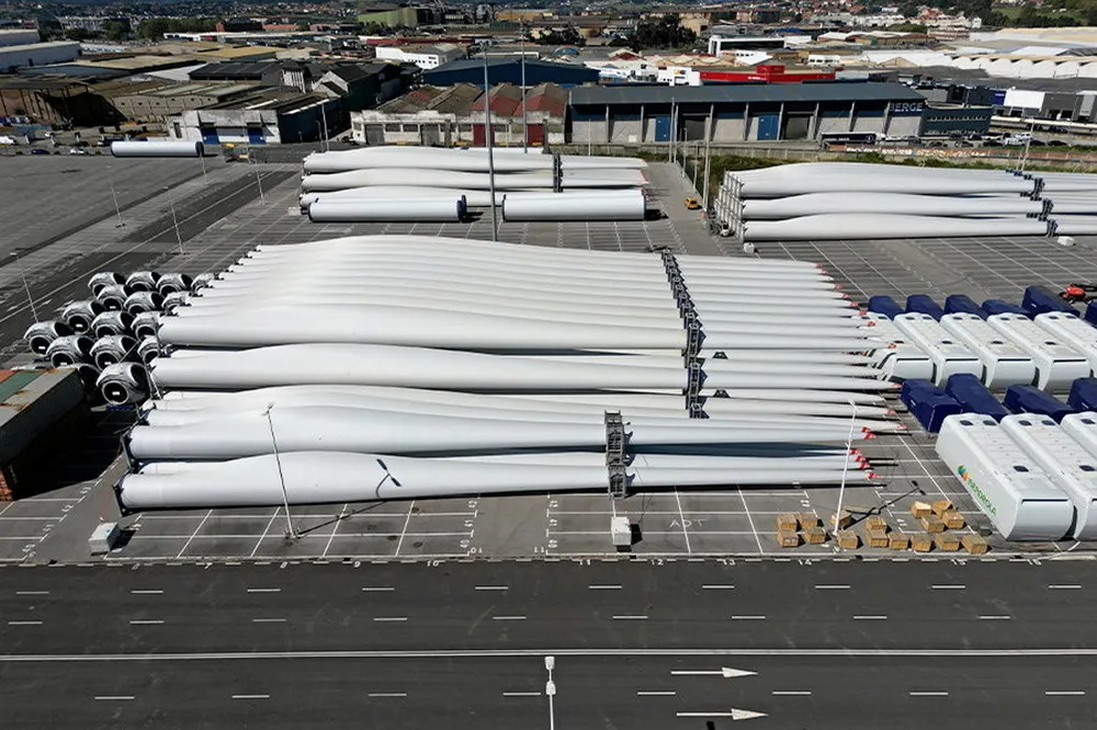 Wind turbine blades stacked awaiting deployment.