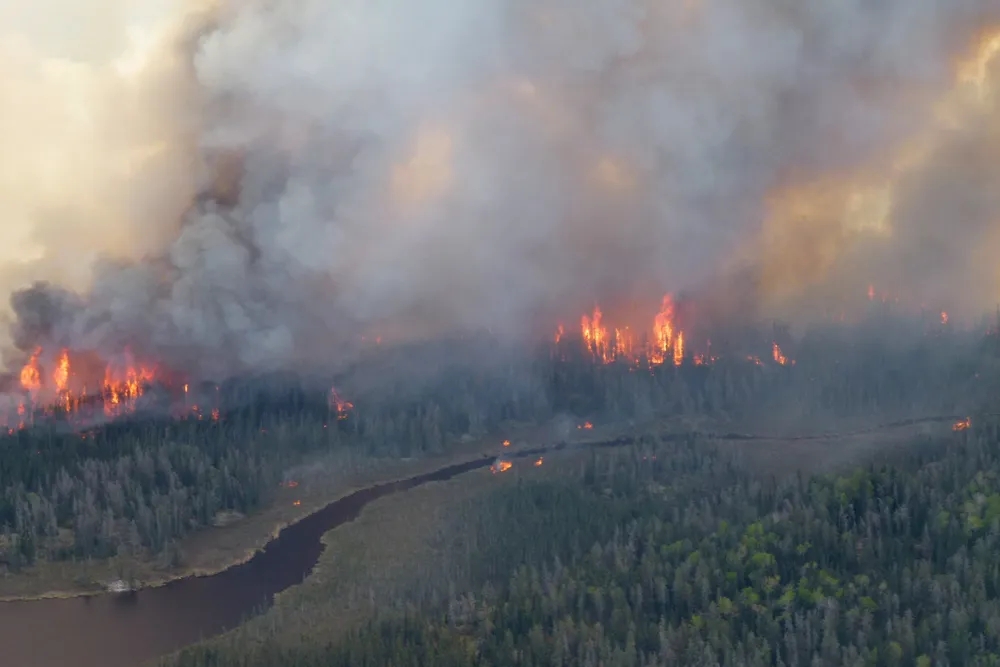 Smoke rises from the Nopiming Provincial Park wildfire east of Bird River, Manitoba, Canada, on 29 May 2025.