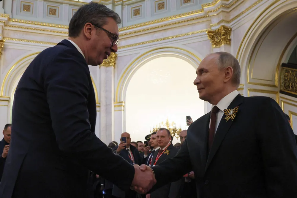 Russia's President Vladimir Putin (right) shakes hands with Serbian President Aleksandar Vucic in the Kremlin, Russia