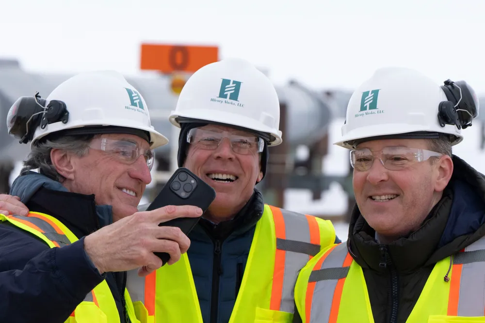 US Interior Secretary Doug Burgum (left), US Energy Secretary Chris Wright (centre) and EPA Administrator Lee Zeldin smile after posing for a photo - on 2 June 2025 - with the Trans-Alaska Pipeline in the background.