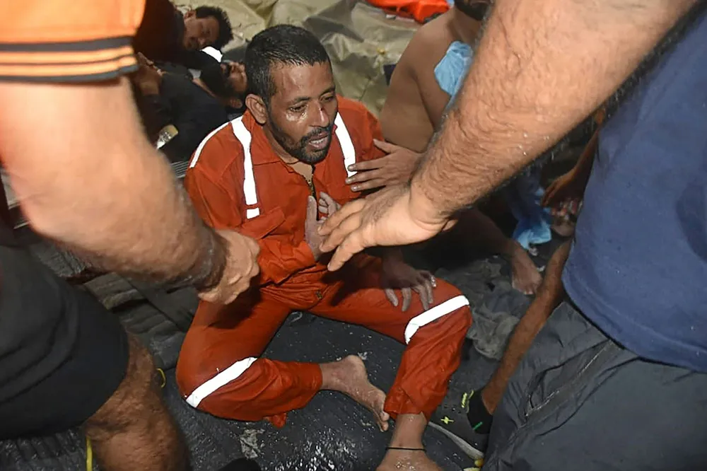 Saved: Indian Navy personnel onboard vessel INS Kochi help injured people rescued from Afcons' barge Papaa 305, which sank in the Arabian Sea