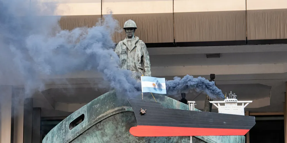 Ocean Rebellion protestors raise a mock polluting ship flying the flag of Argentina, which opposes a 50% reduction in greenhouse gas emissions by 2030.