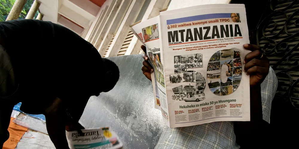 A man reads a newspaper in Tanzania.