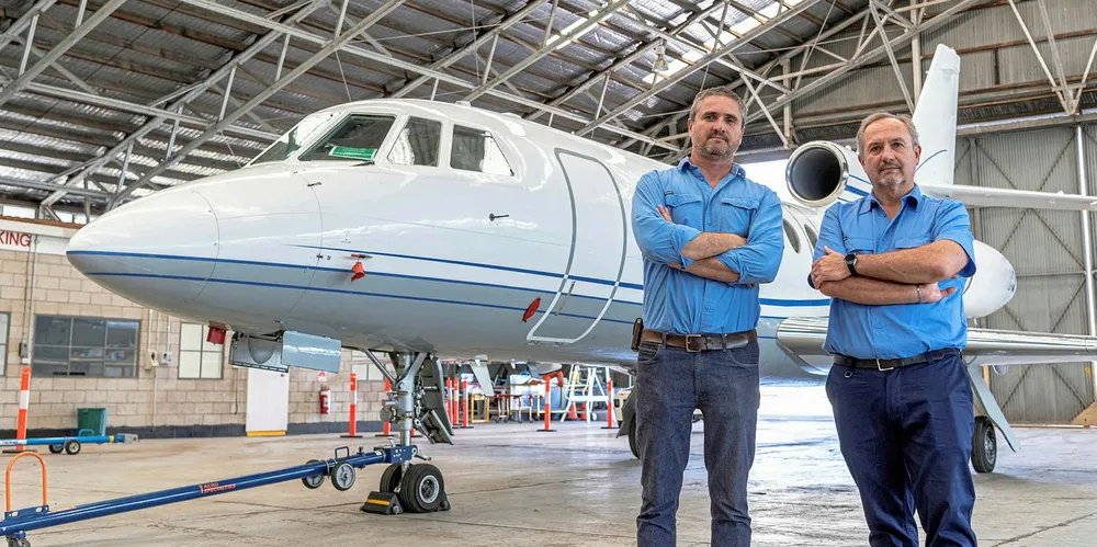 Helmut Mayer (right) and his brother Christof, who are both directors of Aviation H2, in front of the Falcon 50 private jet they want to convert to run on liquid ammonia.