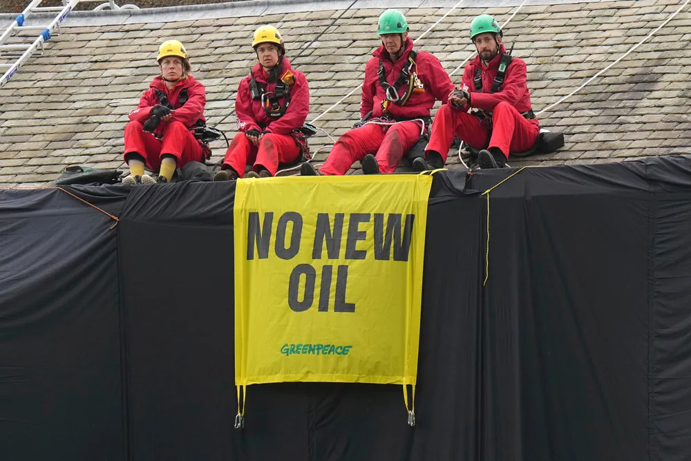 Protest: Greenpeace activists on the roof of UK Prime Minister Rishi Sunak’s house in North Yorkshire, England, after covering it in black fabric.