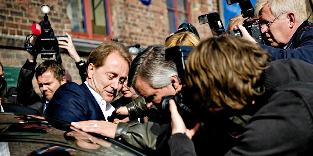 Kjell Inge Rokke is surrounded by press in his native Norway.