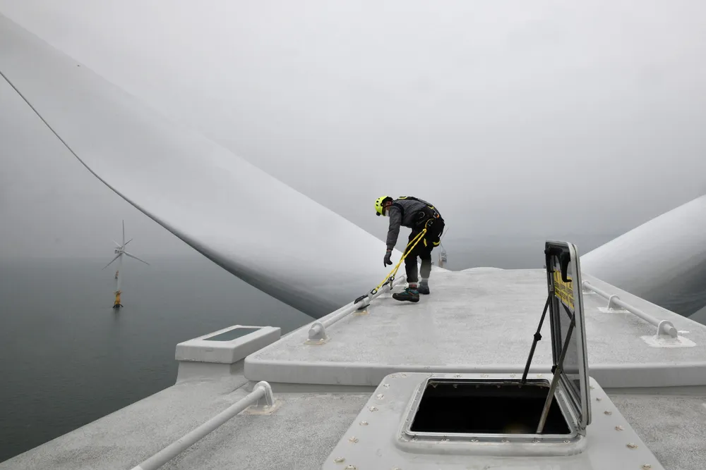 An offshore wind worker carries out maintenance on a turbine.