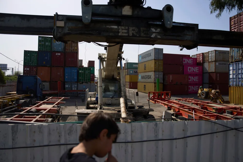 A boy looks at shipping containers in Haifa’s port in April.