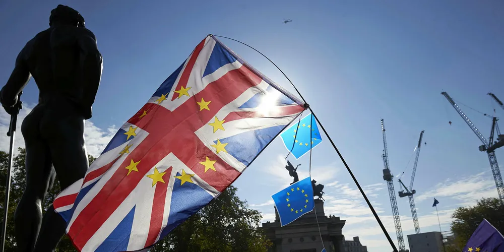 Demonstrators wave a Union flag and European Union flags as they take part in a march calling for a People's Vote on the final Brexit deal, in central London on October 20, 2018.