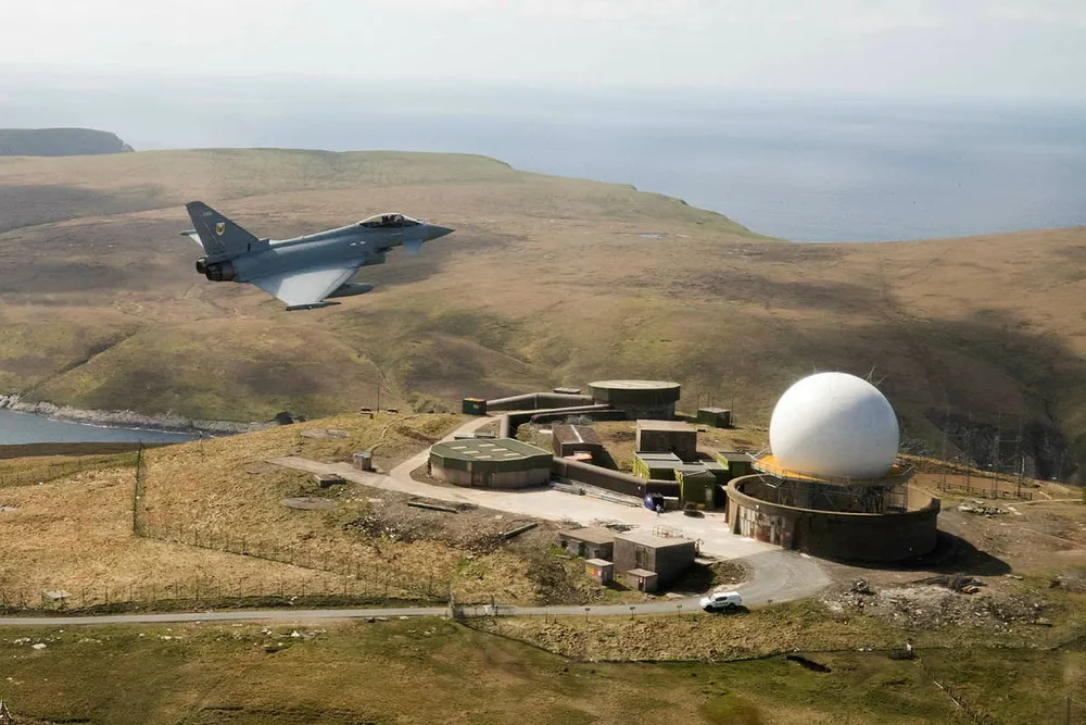A RAF Typhoon flies over an Air Defence Radar.