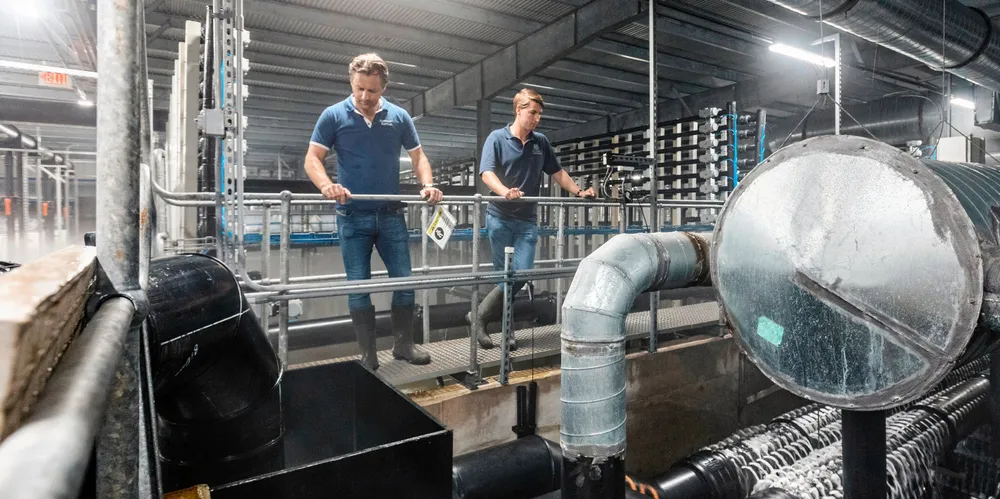Atlantic Sapphire Chairman and co-founder Johan Andreassen (left) and Finance Director Karl Oystein Oyehaug look down at the company's Miami operations.