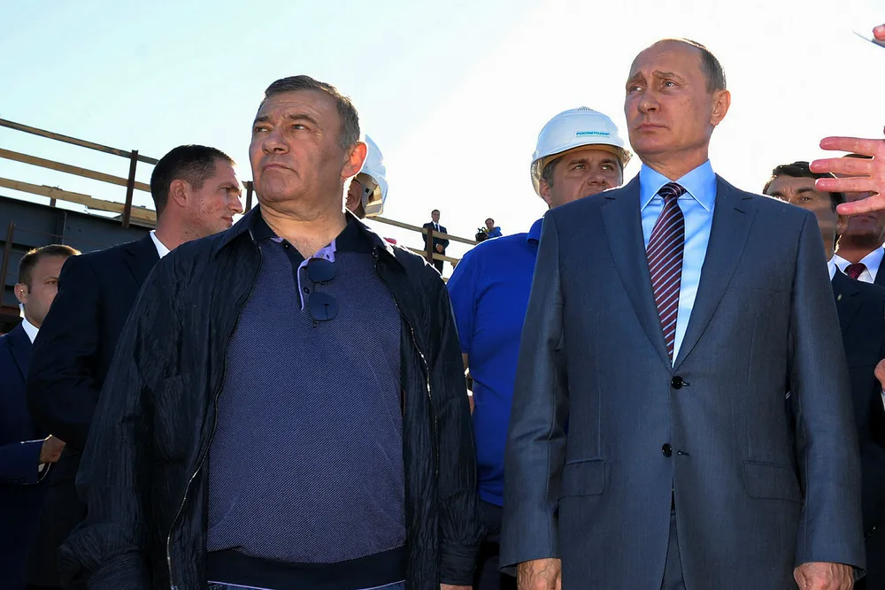 Lucrative awards: Russian President Vladimir Putin (right) stands next to businessman Arkady Rotenberg, who expanded into gas and LNG projects after earning billions of dollars in pipeline construction contracts from Gazprom