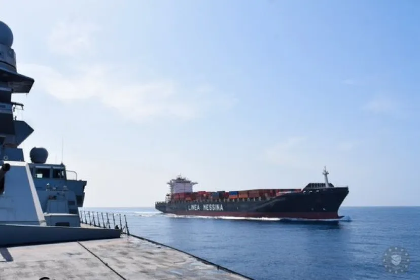 A Messina Lines container ship crosses the Red Sea in May 2025 under the protection of a war vessel from EUNavfor Aspides.