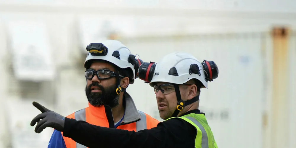 Fred Olsen. Technicians working together on project.