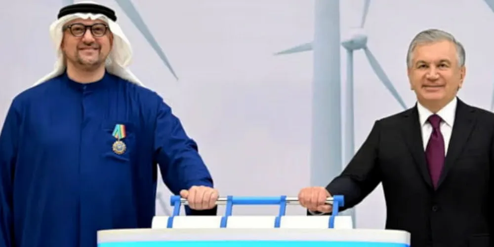 Uzbekistan's President Shavkat Mirziyoyev (R) enacts ceremonial grid connection with Masdar CEO Mohamed Jameel Al Ramahi