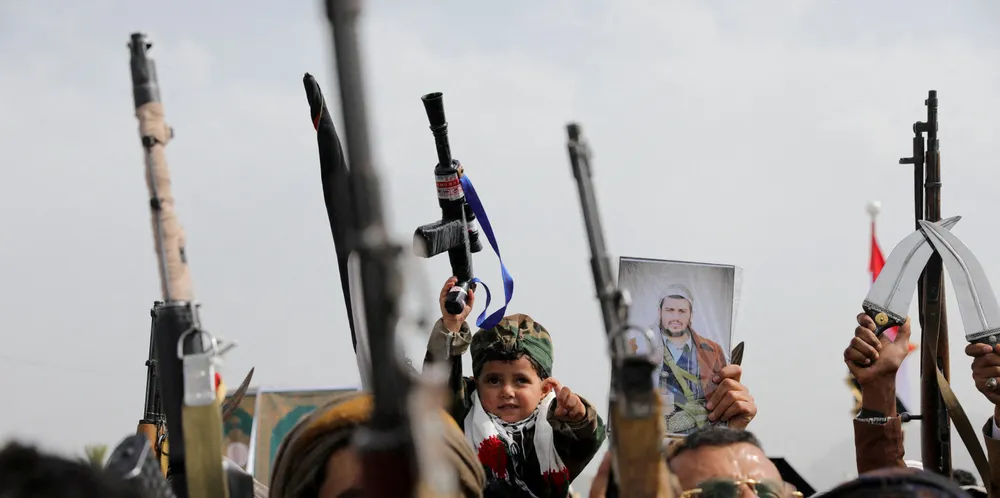 A child holds a toy gun as protesters, mainly Houthi supporters, rally in Sanaa, Yemen on Friday to show solidarity with Palestinians in the Gaza Strip.
