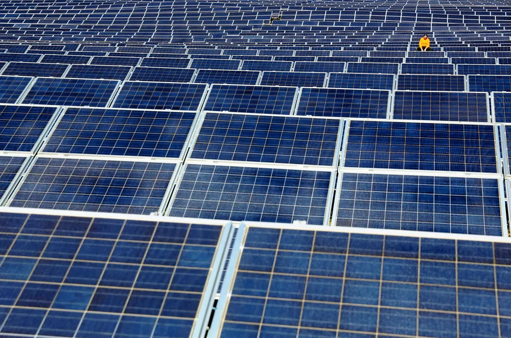 A maintenance man works on crystalline-silicon solar panels at an array in northern Spain.