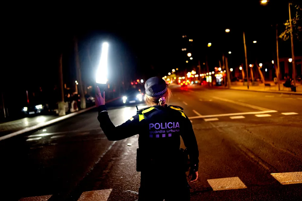Spania ble mørklagt 28. april, og dro med seg nabolandet Portugal. Bildet viser en politikvinne som måtte dirigere trafikken etter at mørket hadde senket seg i Madrid.