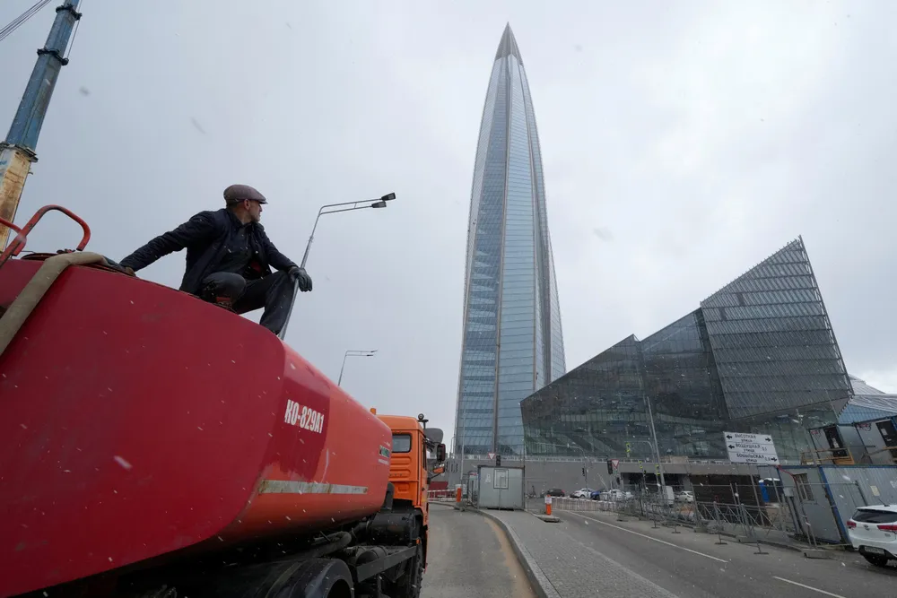 Looking east: a worker sits on a water tank truck next to the Lakhta Centre in St Petersburg, where Russian gas giant Gazprom has its headquarters