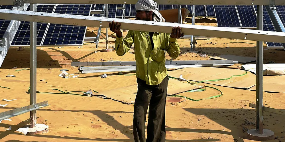 An Indian engineer fixes a solar panel into position in the western state of Rajasthan.