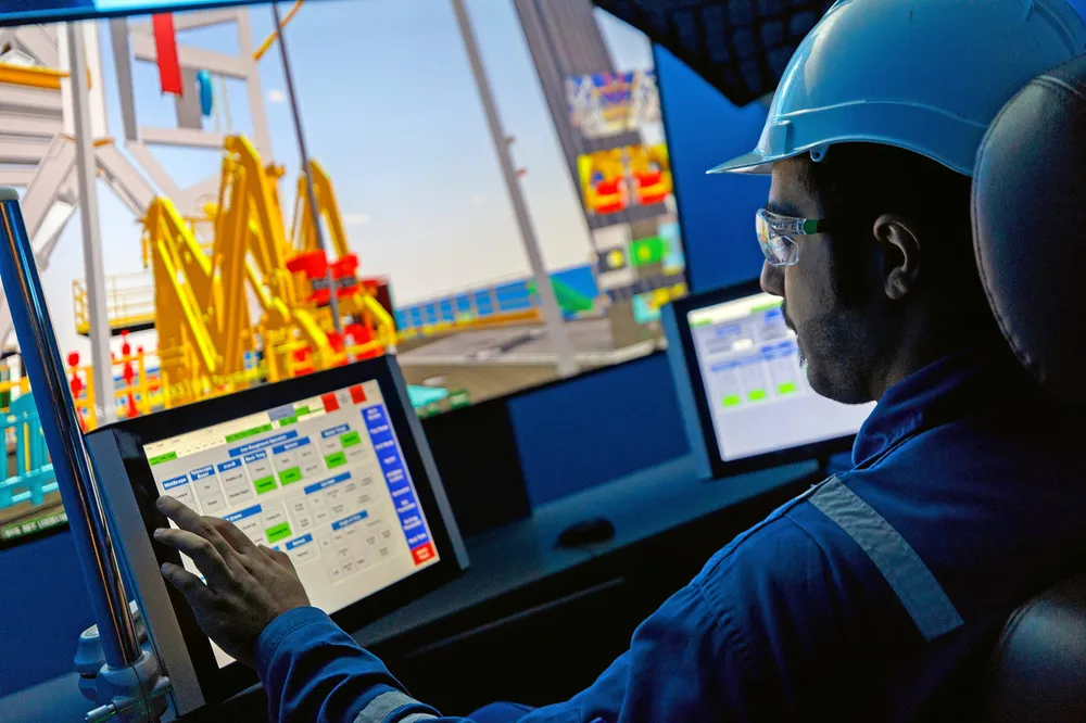 Framework deals: an operator at an Adnoc Drilling site.