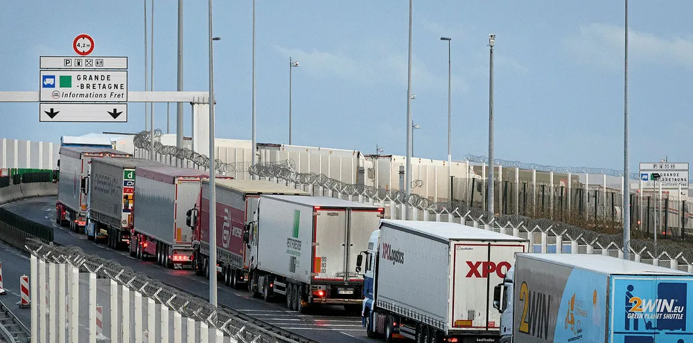 A line of trucks snakes along an access road leading towards the port of Calais.