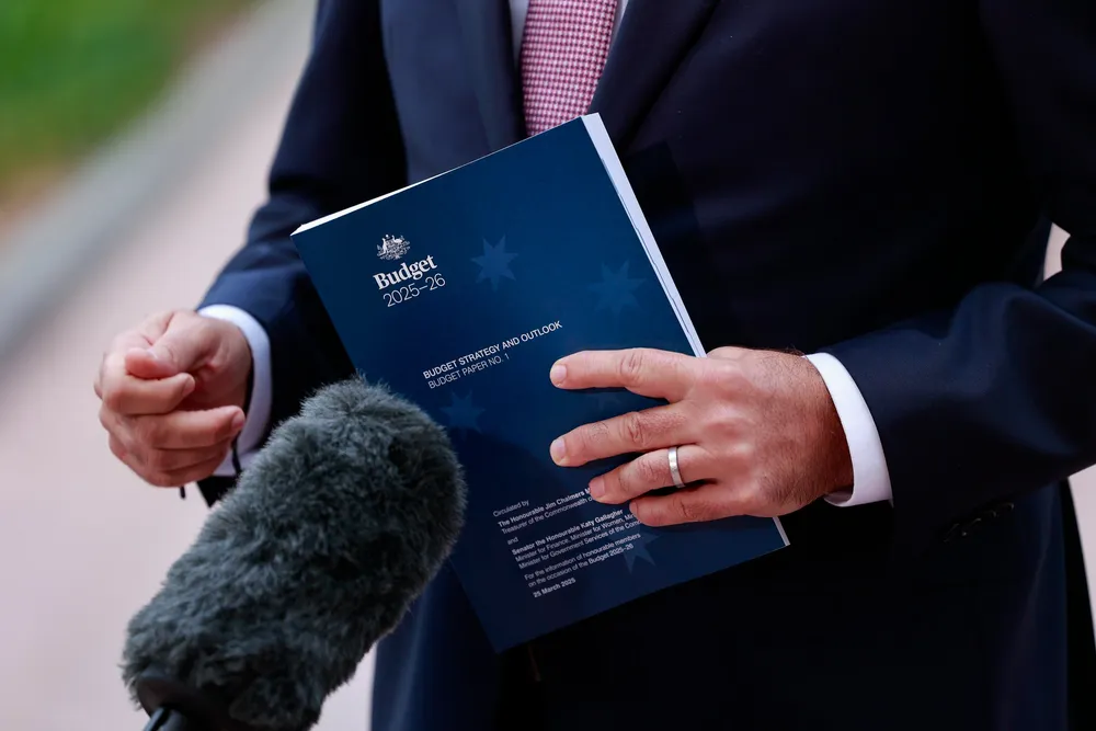 A copy of the Federal Budget in the hands of Australia's treasury chief Jim Chalmers
