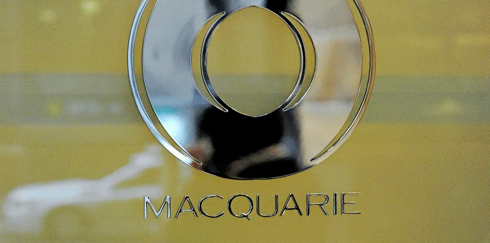 A street scene is reflected in the logo of Macquarie Bank.