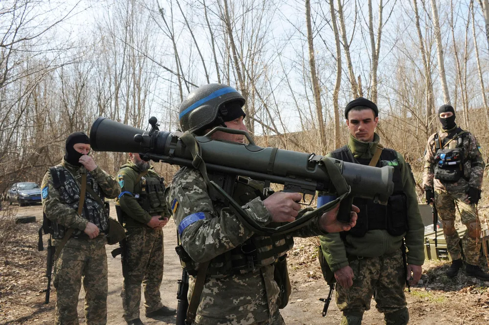 Breaking the bond: Ukrainian servicemen study a Swedish shoulder-launched weapon system during a training session near Kharkiv, Ukraine in April 2022