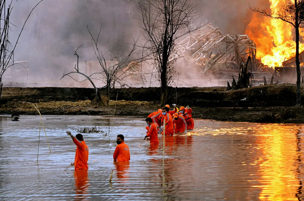 Rescue operation: National Disaster Response Force personnel at the site of the fire at Baghjan