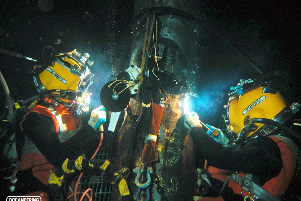 Oceaneering Saturation Diver/Welders welding a Castellation Sleeve on one of five X-Braces replaced on a hurricane damaged platform in the Gulf of Mexico.