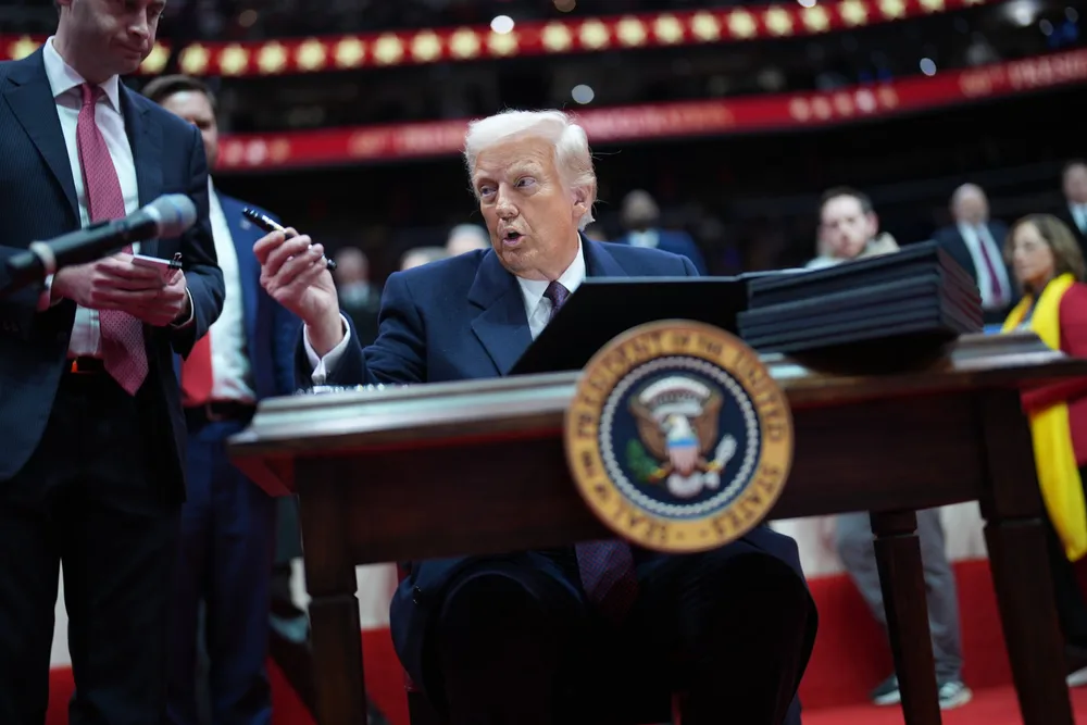 President Donald Trump signs executive orders during an event at Capital One Arena, part of the 60th inaugural ceremonies on January 20, 2025, in Washington, DC.