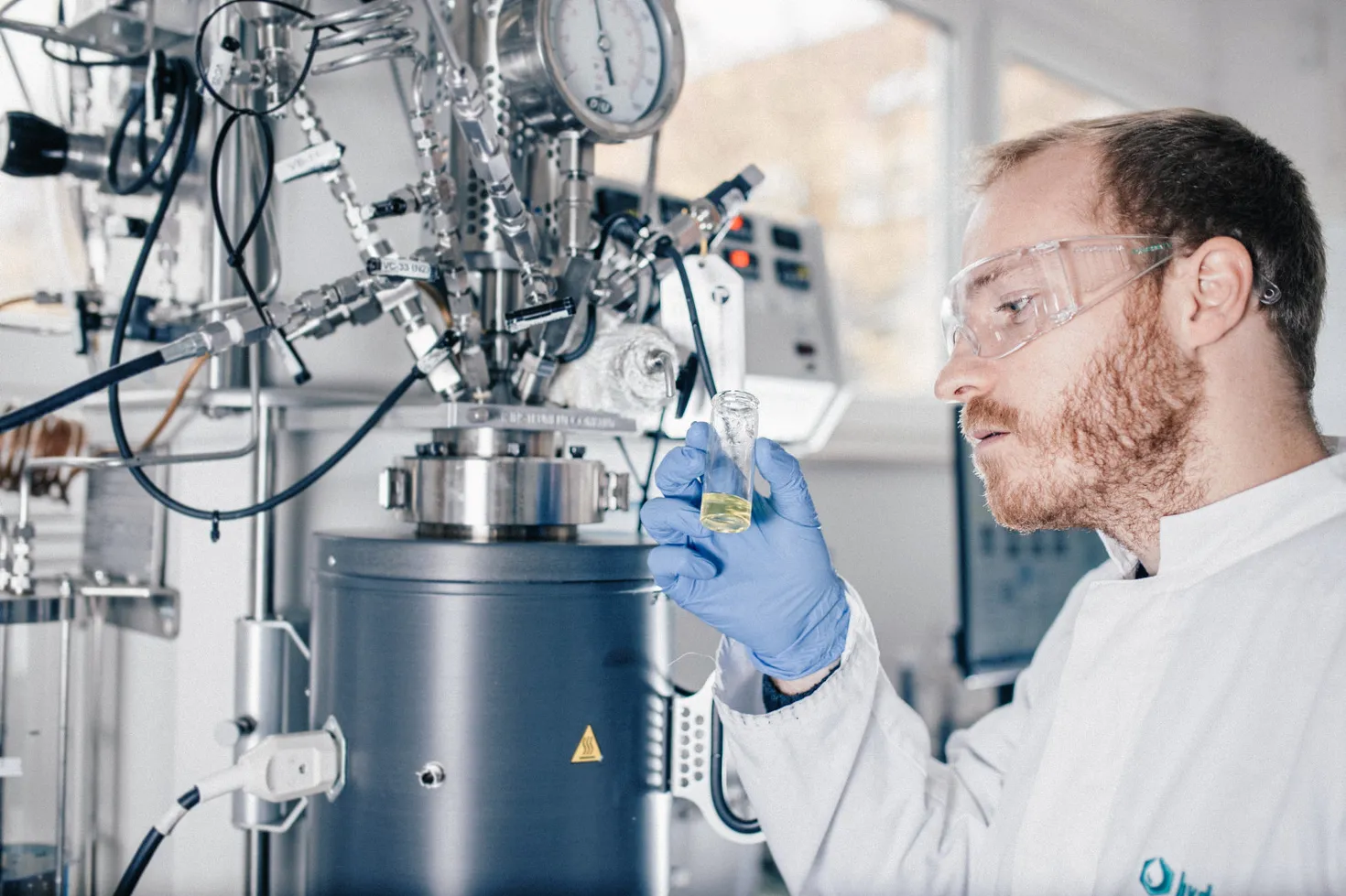 A researcher with a sample of LOHC.